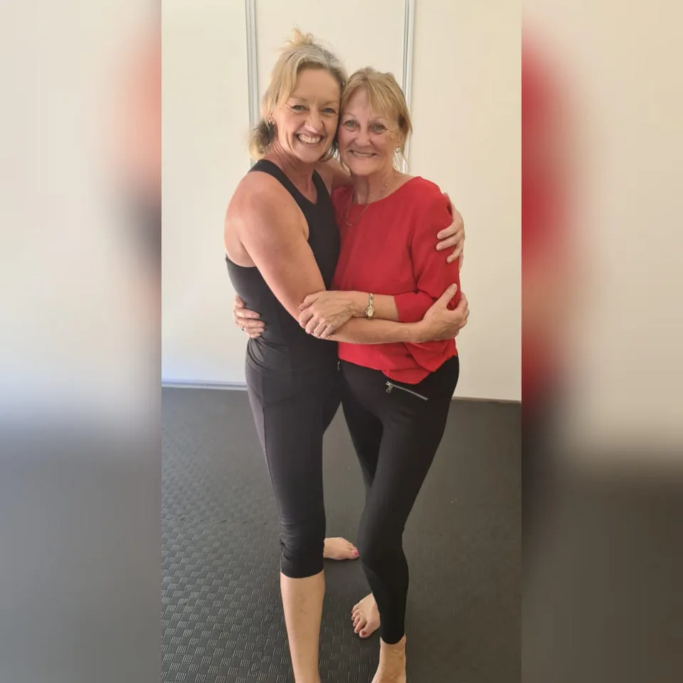 Debi sharing a warm hug with a student in the studio